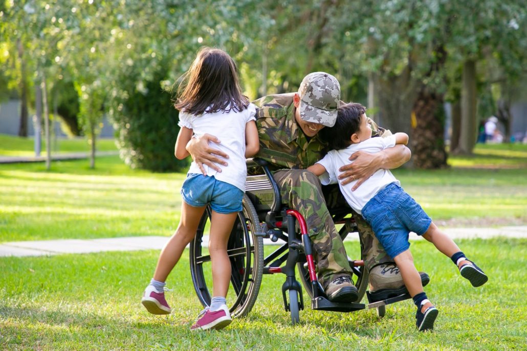 disabled veteran playing with his kids while protected by disability coverage